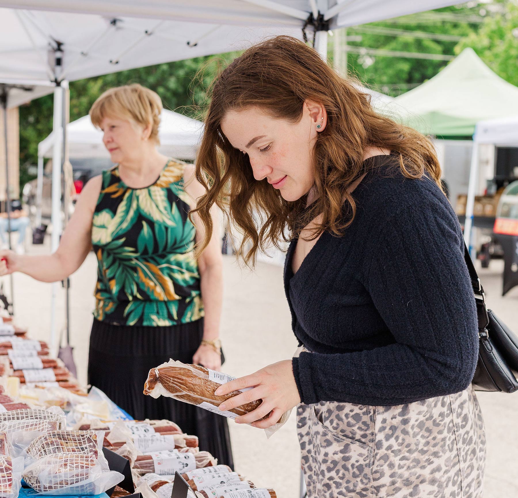 Cleo and Jeryn Decoppel shopping at the local farmers market in Saugeen Shores